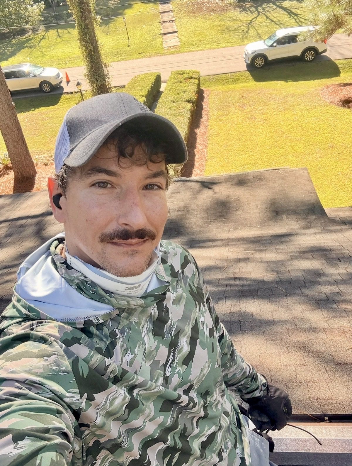 Josh the owner of SouthScape Co. working on top of a roof in Hattiesburg Mississippi
